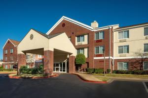 a large brick building with a roof on a street at Fairfield Inn and Suites Memphis Germantown in Memphis