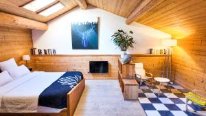 a bedroom with a bed and a tv in a room at Le Grenier 1821 - Mini chalet - Centre village - AravisTour in Saint-Jean-de-Sixt +14 photos