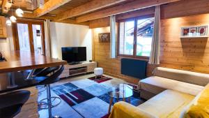 a living room with a couch and a table at Le Grenier 1821 - Mini chalet - Centre village - AravisTour in Saint-Jean-de-Sixt