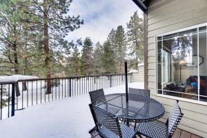 a table and chairs on a balcony with snow at Klamath Falls Townhome with Deck and Resort Amenities! in Klamath Falls