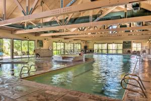 a swimming pool with chairs in a large building at Klamath Falls Townhome with Deck and Resort Amenities! in Klamath Falls