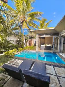 a swimming pool in the backyard of a villa at Tropical Villa - 3 Bedrooms in the heart of Grand-Baie in Grand Baie