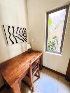 a wooden table in a room with a window at Tropical Villa - 3 Bedrooms in the heart of Grand-Baie in Grand Baie