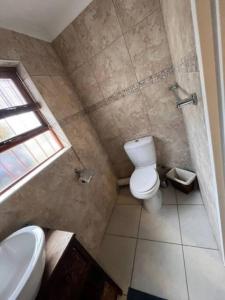 a small bathroom with a toilet and a sink at Lovely Garden Studio1 - 10 minute walk from beach in Cape Town