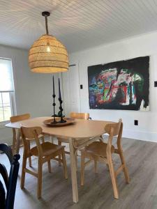 a dining room table with a lamp and chairs at Cramerton/Belmont's Modern and perfect retreat in Cramerton