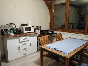 a kitchen with a table and a microwave at Central Hostel Cluj in Cluj-Napoca