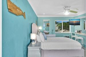 a bedroom with a bed and a fish on the wall at Walkabout 6 Suite on Hollywood Beach with Ocean Views in Hollywood