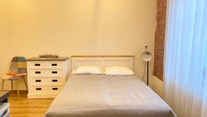 a small bedroom with a bed and a dresser at Filosoofi 1 Studio Apartments in Tartu