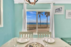 a dining room with a table with a view of the beach at Panoramic beachfront Suite in Hollywood