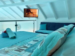 a bedroom with a bed and a flat screen tv at Sun Caraibes in Orient Bay
