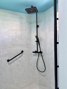 a shower with a shower head in a bathroom at Sun Caraibes in Orient Bay