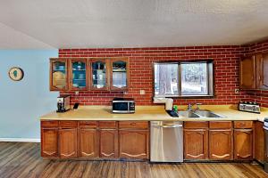 a kitchen with a sink and a brick wall at Hobart Haven in South Lake Tahoe
