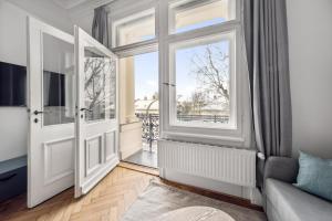 a living room with a door and a window at limehome Dresden Antonstraße in Dresden