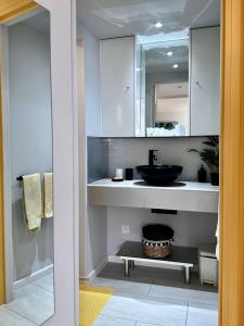 a bathroom with a sink and a mirror at Sun Caraibes in Orient Bay
