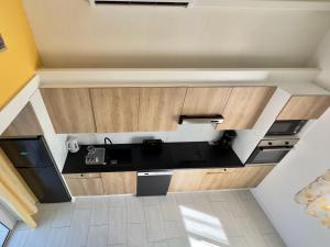 an overhead view of a kitchen with wooden cabinets at Sun Caraibes in Orient Bay