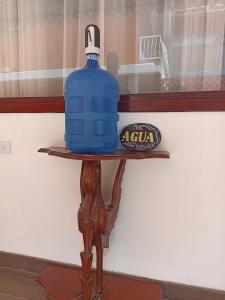 a large blue water bottle sitting on a wooden table at Posada J in Baños