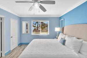 a blue bedroom with a bed and a ceiling fan at Walkabout 8 Tower Suite with Panoramic Ocean Views in Hollywood