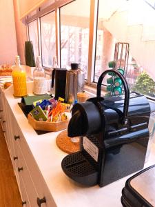 a kitchen counter with a hair dryer on top of it at Le Premier Lisbon Suites in Lisbon