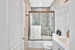 a bathroom with a toilet and a sink at Walkabout 8 Tower Suite with Panoramic Ocean Views in Hollywood