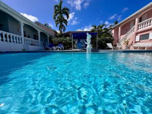 a large swimming pool in front of a building at Sun Caraibes in Orient Bay