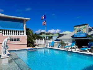 a swimming pool at a resort with a flag at Sun Caraibes in Orient Bay