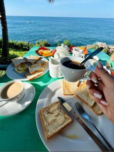 une table avec une assiette de nourriture sur l'océan dans l'établissement Perfect view mirissa, à Mirissa