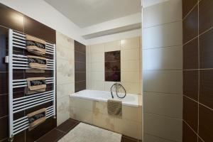 a bathroom with a bath tub and a sink at Relax apartment Bratislava in Bratislava