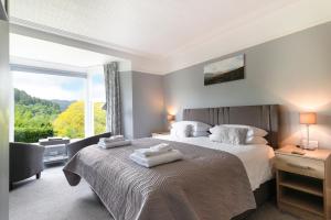 a bedroom with a bed and a large window at Aberconwy House B&B in Betws-y-coed