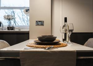 a table with a plate and a wine glass at Windsor Court in Brighton & Hove