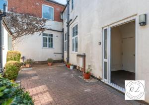 an empty courtyard of a house with a garage at Comfy Modern 2 Bed near Glenfield Hospital, sleeps up to 6 in Glenfield