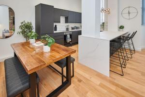 a kitchen and dining room with a wooden table at Host & Stay - Princes Place Hideaway in Liverpool
