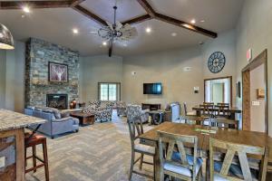 a living room with a table and a fireplace at Modern Lead Cabin with Hot Tub, 6 Mi to Skiing! in Lead