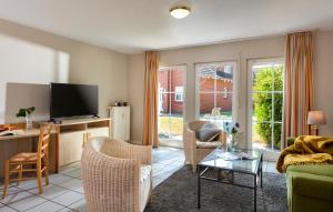 Precise Resort Rügen Apartments & SPLASH Erlebniswelt的电视和/或娱乐中心