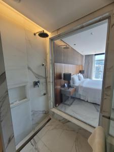 a bathroom with a shower and a bedroom with a bed at Hotel Nacional in Rio de Janeiro
