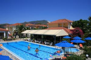 a group of people playing in a swimming pool at Metaxa Hotel in Kalamaki