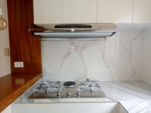a stove top in a kitchen with marble counter top at Casita de Zacate in Cagayan de Oro
