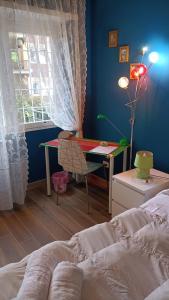 a bedroom with a bed and a desk and a window at Colombo Holidays APT in Rome