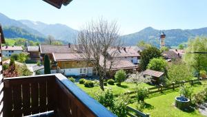 a view from a balcony of a town with a garden at Ferienwohnung Dehnert in Fischbachau