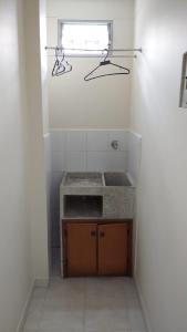 a bathroom with a sink and a window at San Juan Del Lago in Pereira