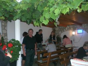 a man standing in a restaurant with a group of people at Ferienwohnungen Feldsee in Illmitz