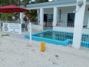 a fence in front of a house with a swimming pool at casa de los abuelos in San Crisanto
