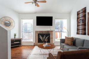 a living room with a couch and a tv at Locale Bouldin Creek - Austin in Austin