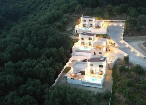an aerial view of a house with lights on at Merelia Exclusive Villas in Parga
