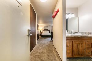 a bathroom with a sink and a bed in a room at Studio Queen Room Ground Floor Unit 113 Bldg B in Truckee
