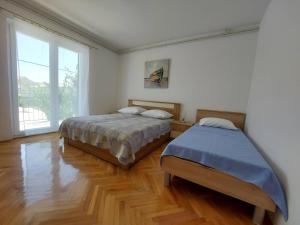 a bedroom with two beds and a large window at NEW! Apartments with shared pool, Vodice in Vodice +44 photos