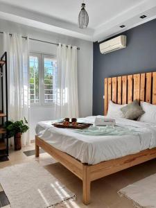 a bedroom with a large bed with a tray on it at Sunny Blue in Sidi Daoud