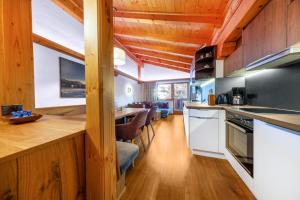 a kitchen with a counter and a dining room at Haus Wildkarblick in Krimml