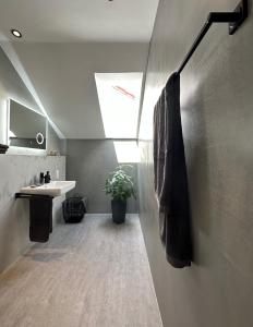 a bathroom with a sink and a towel at Dachstudio Apartment in Ulm in Ulm