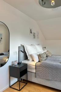 a bedroom with a bed and a table with a mirror at Dachstudio Apartment in Ulm in Ulm