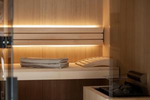 a closet with a shelf with towels on it at Domenigs Luxury Apartments in Fiss